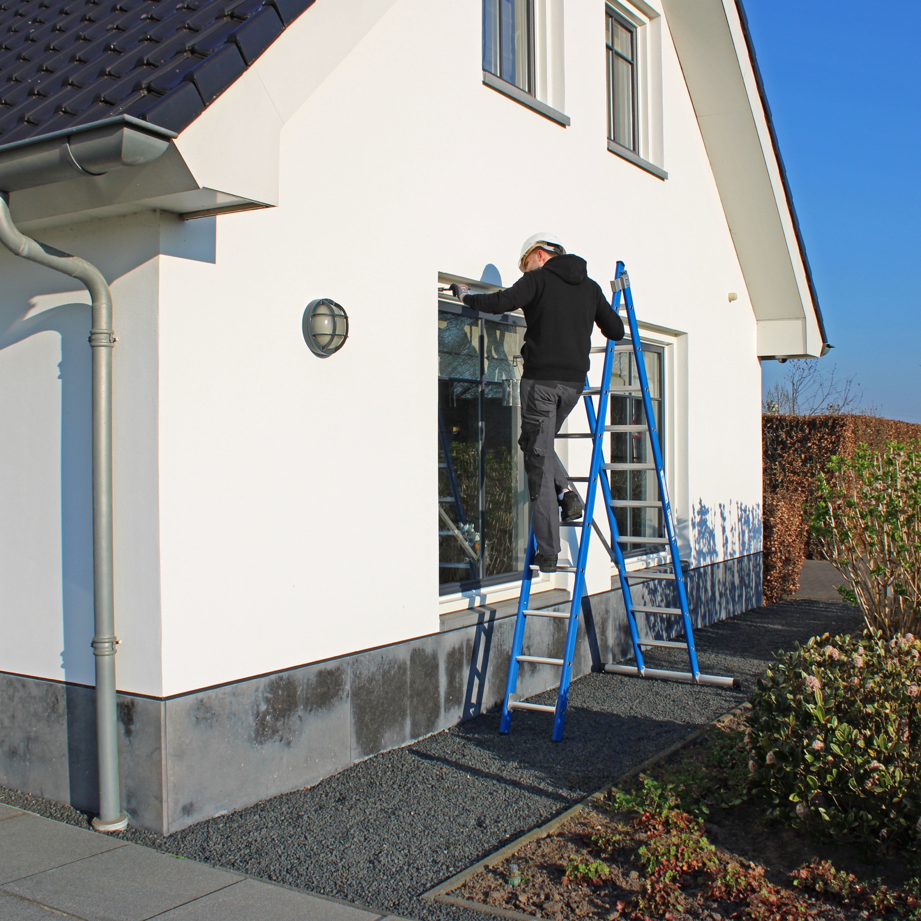 Two-section ladder against a house