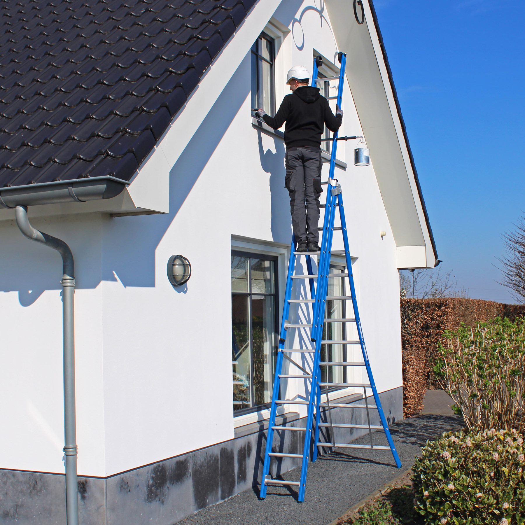Three-section Eurostairs ladder against a house